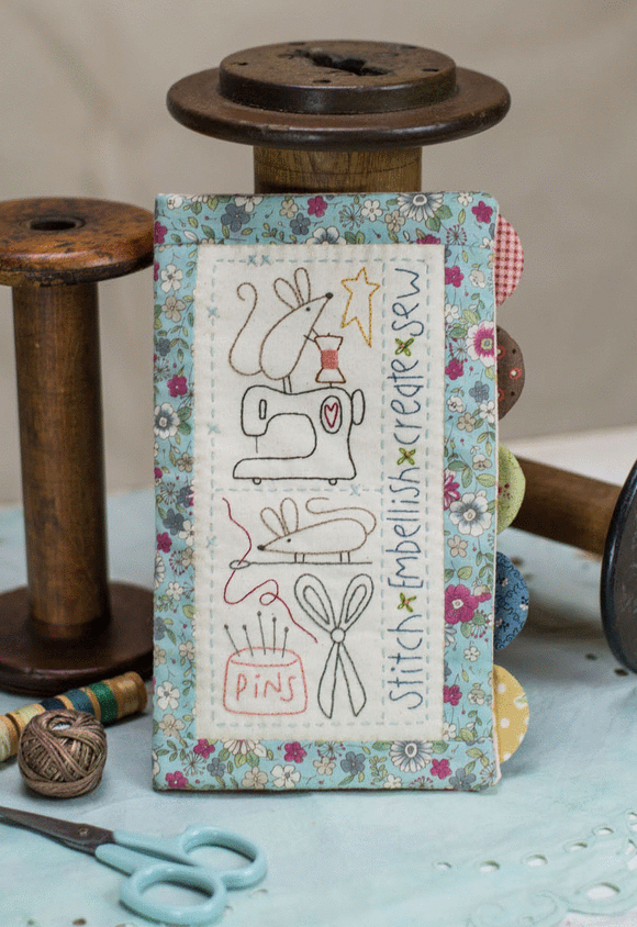 sewing needle book with stitchery design featuring two mice, a sewing machine, scissors and a pincushion